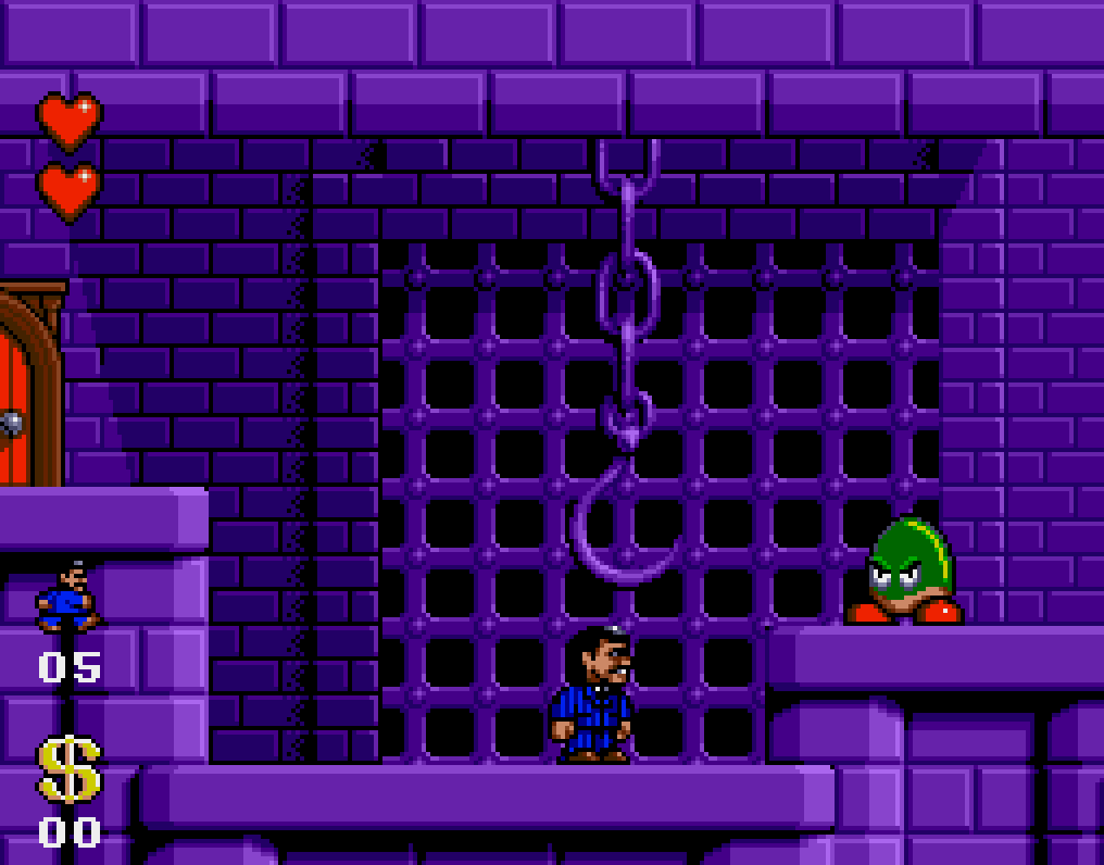 Capture : Gomez sous un crochet suspendu à une chaîne, devant une grille, dans un décor de pierres violettes, avec un monstre vert à droite