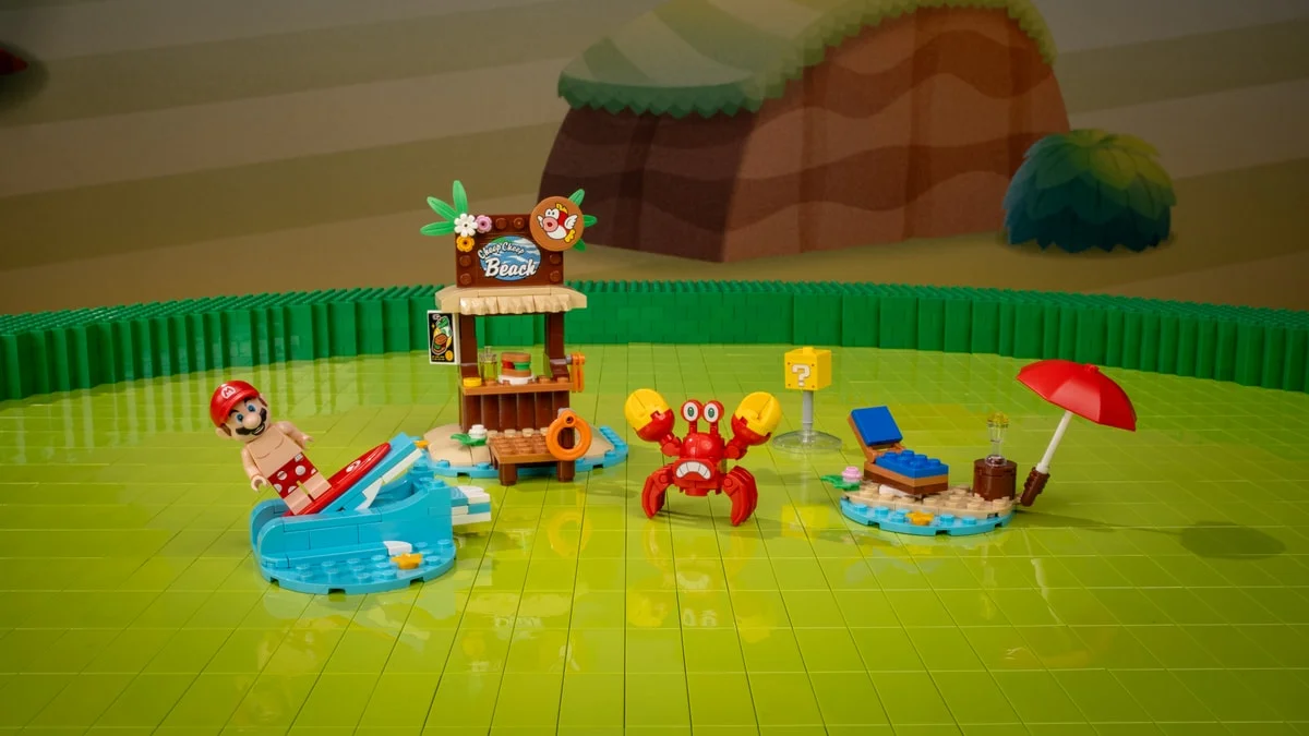 Le set Mario's Beach Adventures : Mario en tenue de bain sur une planche, le comptoir de rafraîchissements Cheep Cheep Beach et l'ennemi Sidestepper en briques rouges.