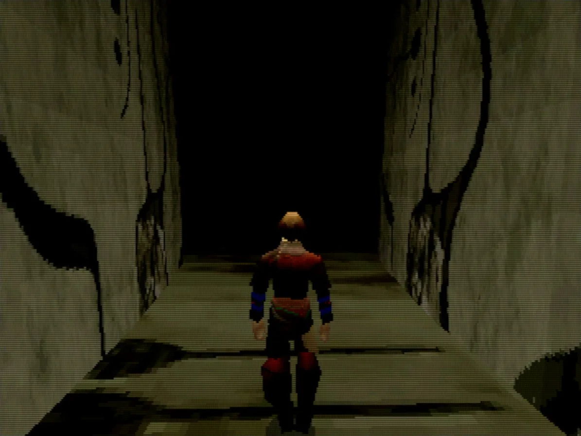 Capture de Panzer Dragoon Saga : le héros, de dos, avance dans un couloir de pierre sombre