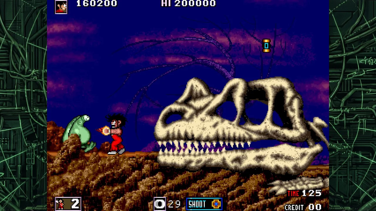 Capture : le héros, petit personnage en pantalon rouge, lance une boule de feu vers une créature verte posée sur un rocher, devant un crâne de dinosaure géant, sous un ciel violet