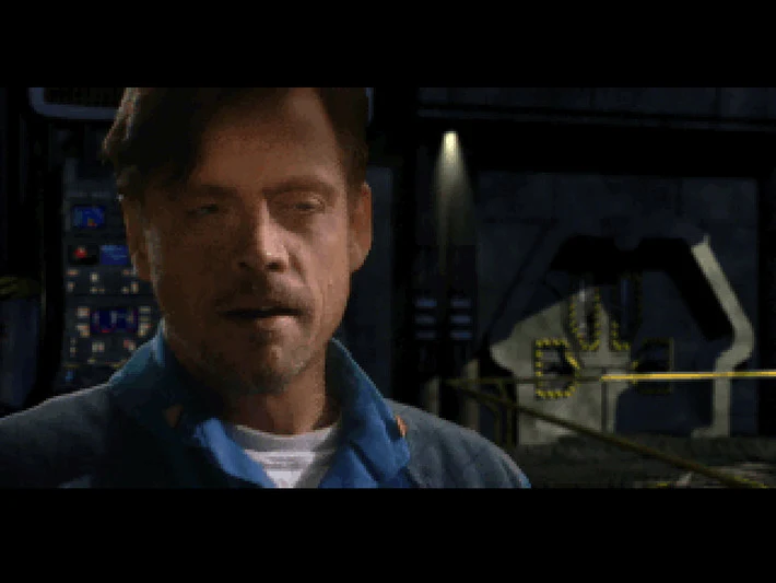 Capture de Wing Commander III : gros plan filmé d'un homme aux cheveux bruns en blouson bleu, dans un hangar