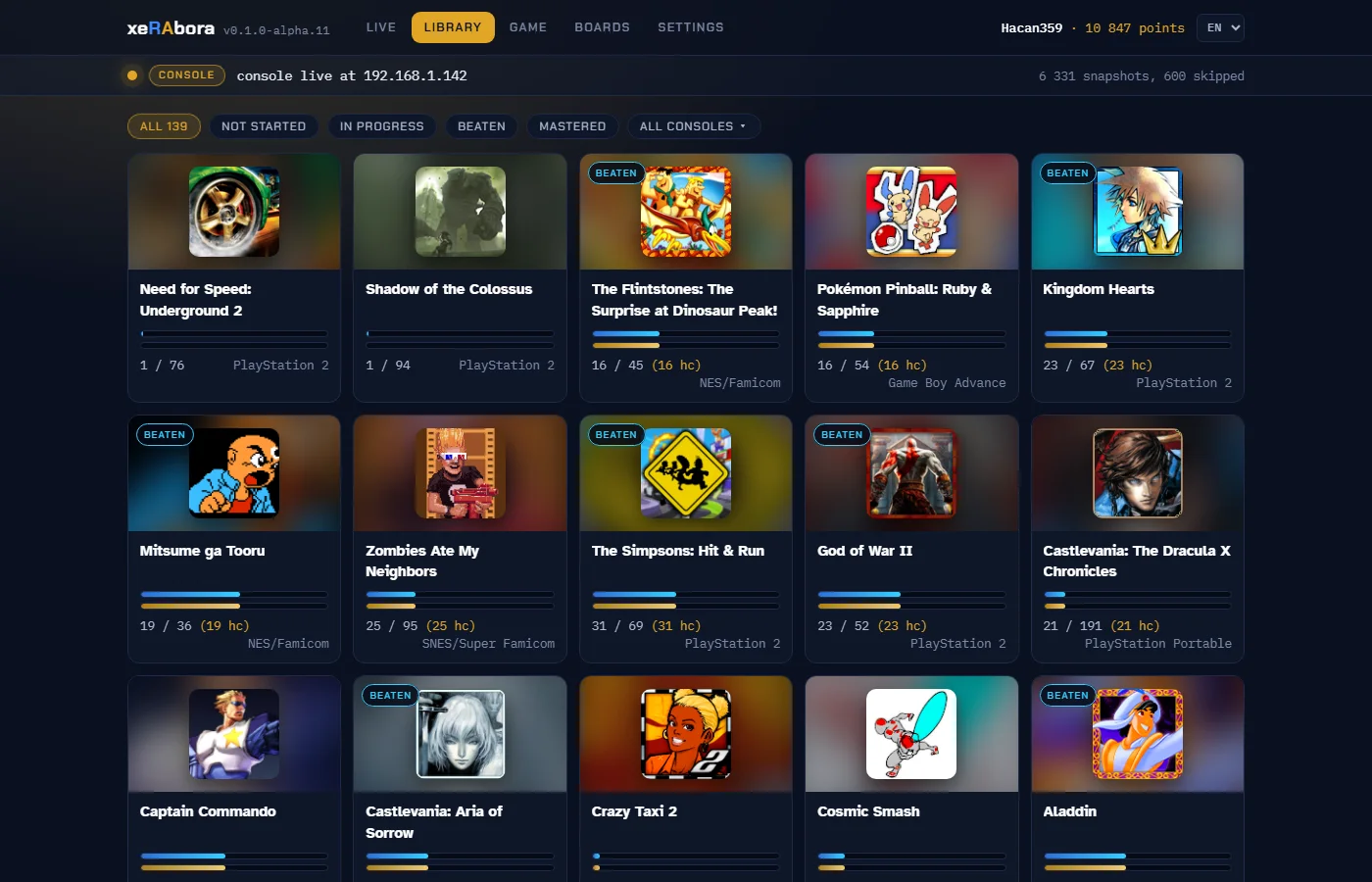 Capture de l'onglet LIBRARY : une grille de jeux du compte, de Need for Speed: Underground 2 à Aladdin, chacun avec son illustration, sa console et ses barres de progression