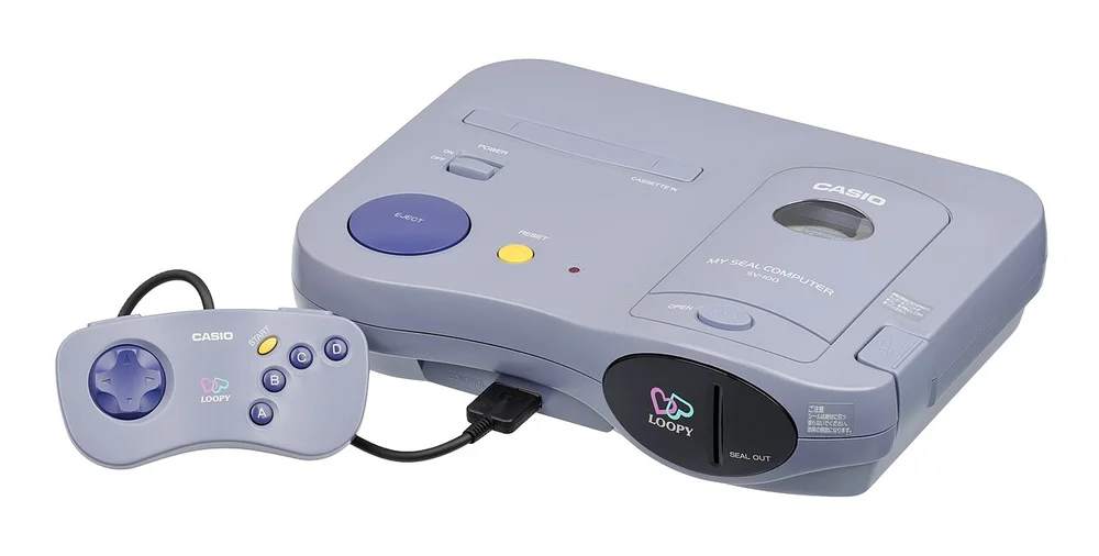 La console Casio Loopy avec sa manette et ses accessoires